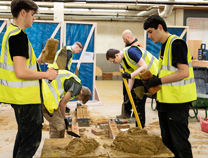 Students bricklaying in workshop